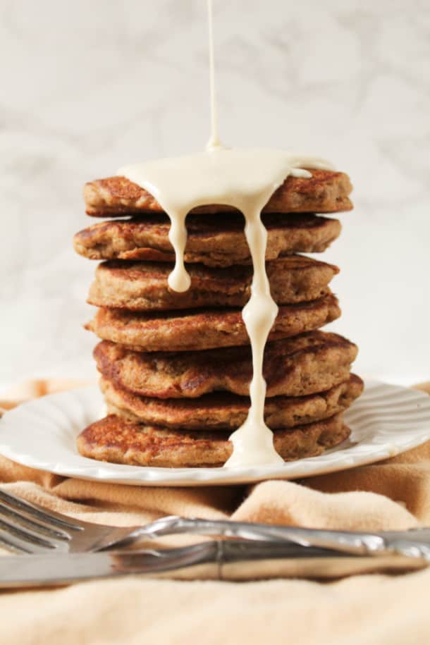 Stack of pancakes on a plate with syrup