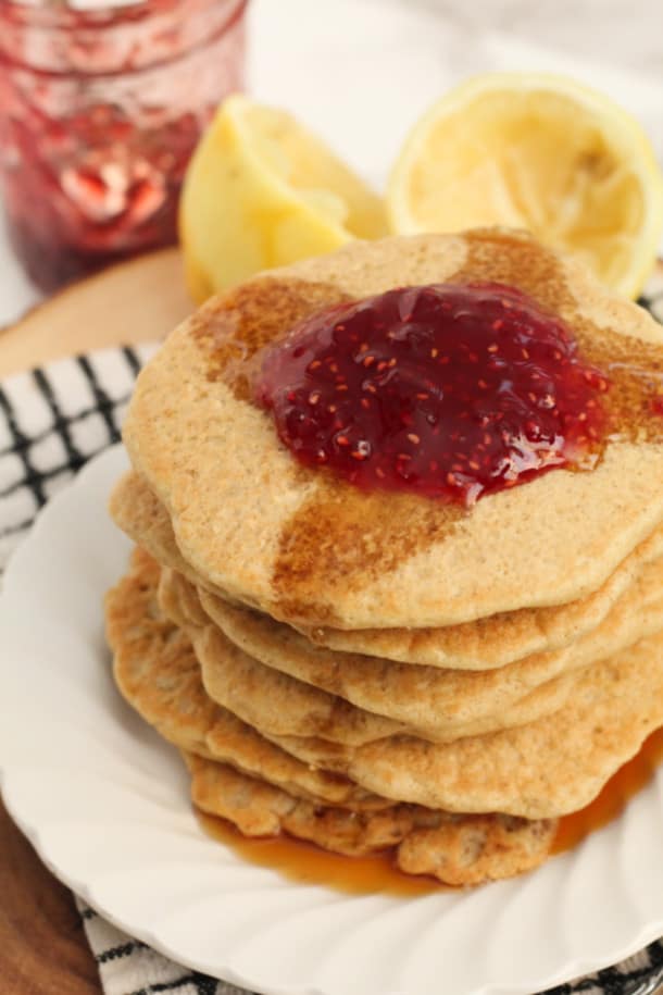 Plate of pancakes with jam and syrup