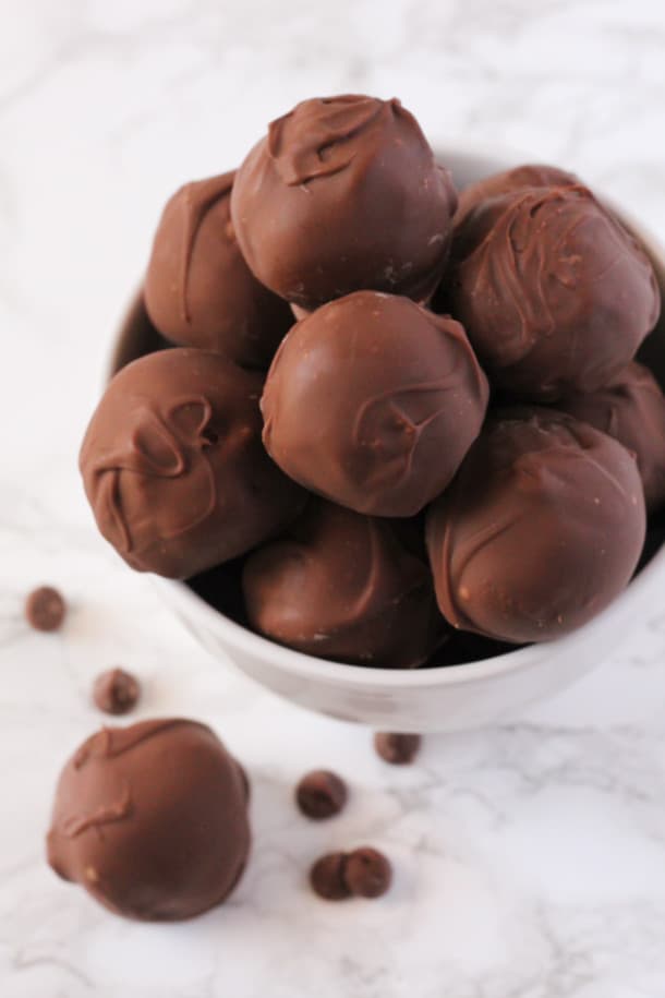 Double Chocolate Truffles stacked high in a bowl with chocolate chips around