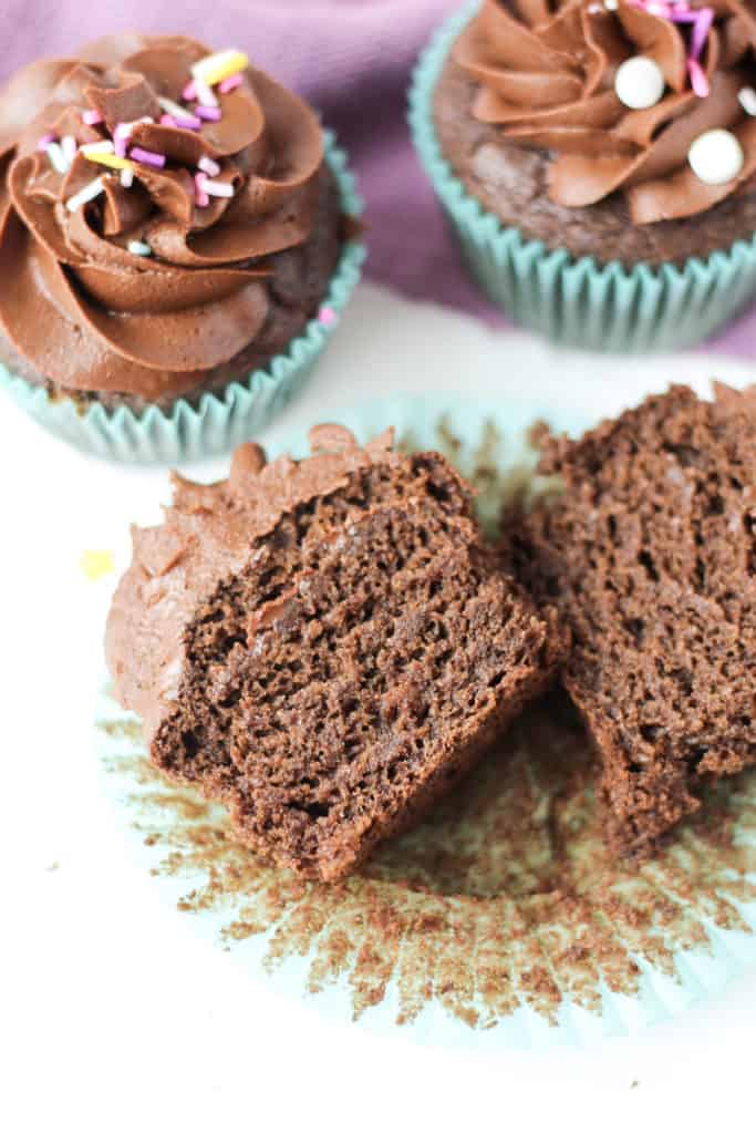 one Chocolate Cupcake cut open to see the inside