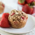 A muffin and strawberries on a plate