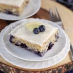 A piece of cake on a plate, with Blueberry
