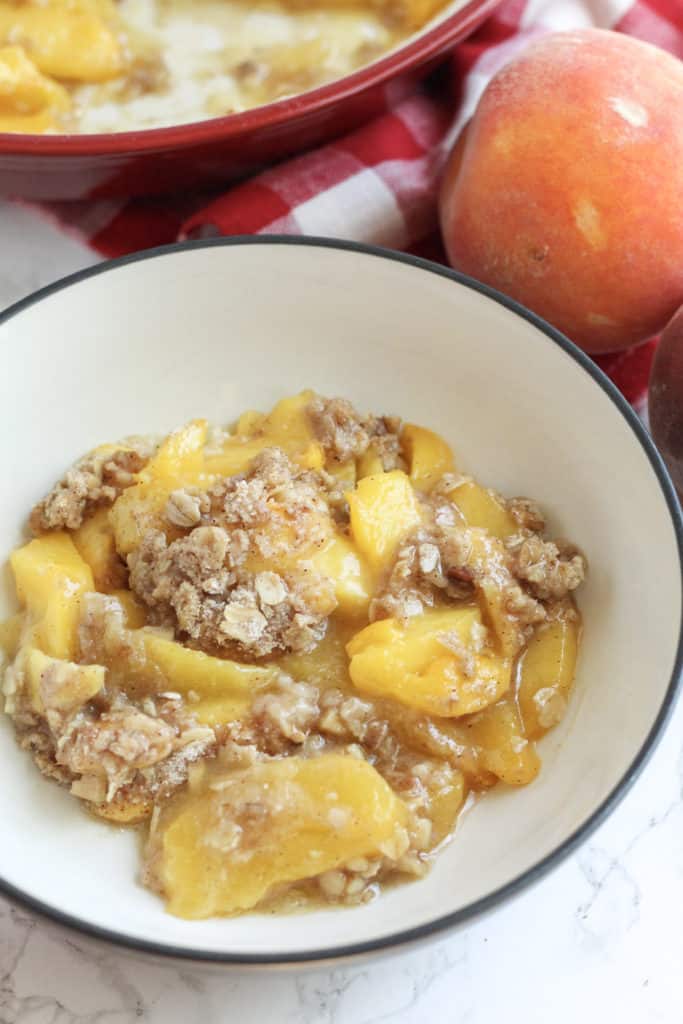 A bowl filled with peach crisp