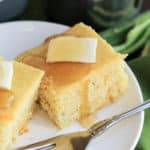 A plate of cornbread with butter and honey