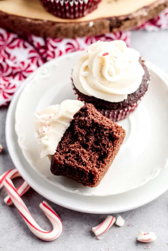 Two Chocolate Peppermint Cupcakes on a plate, with a bite taken out of one