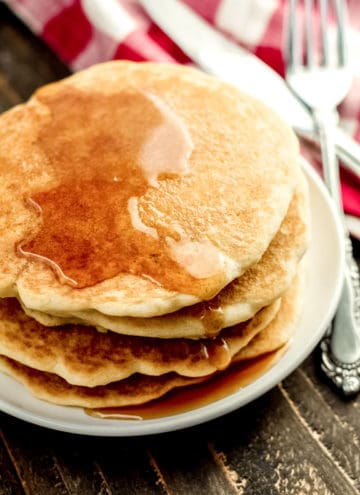 A close up of a stack of pancakes on a plate