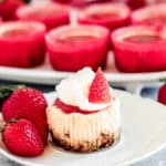 A close up of a slice of cheesecake on a plate, with Strawberry