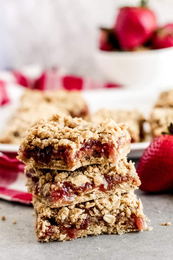 stack of 3 strawberry crumb bars with a bite taken out of the top bar.