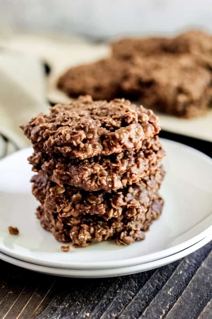 four no bake cookies stacked on a plate with a close up view