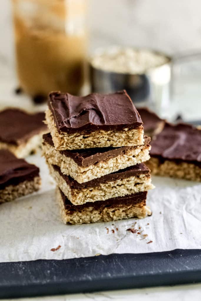 Stack of Chocolate Peanut Butter Oatmeal Bars in front of other bars