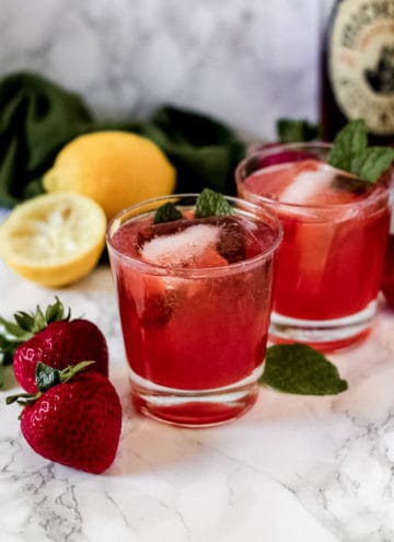 Glass of whiskey smash with strawberry
