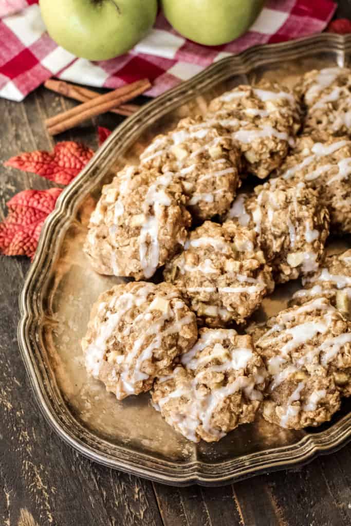 A tray filled with apple cinnamon oatmeal cookies with a glaze drizzled on top