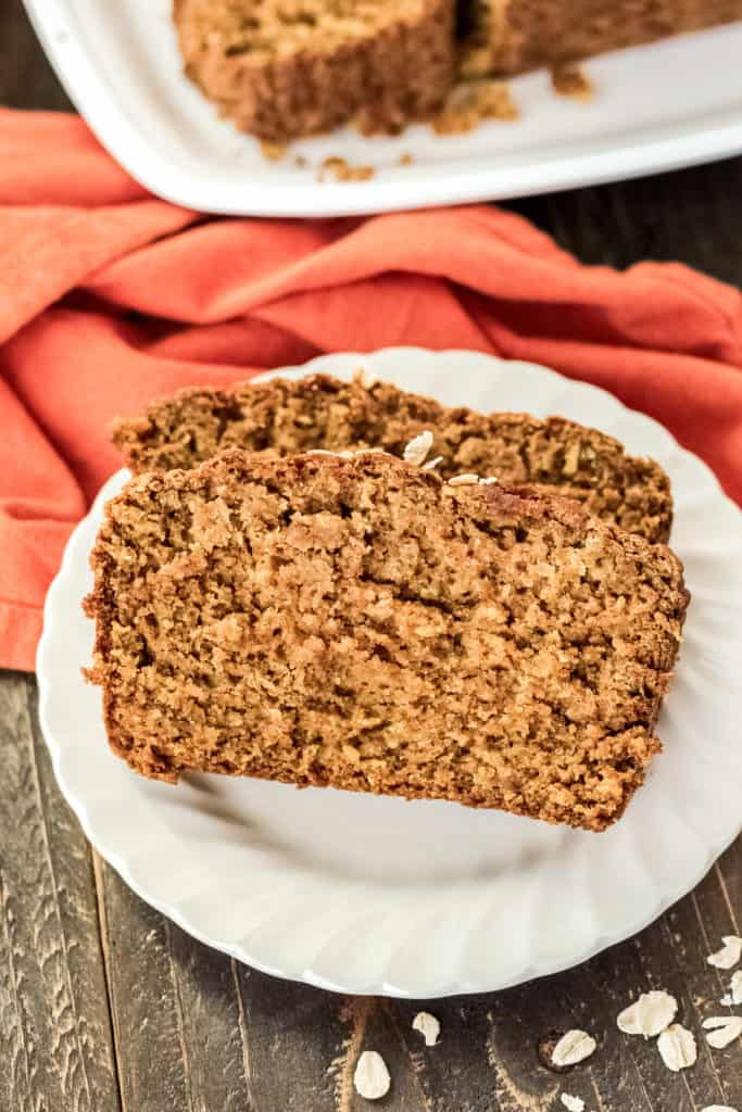 Two pieces of pumpkin oatmeal bread on a plate