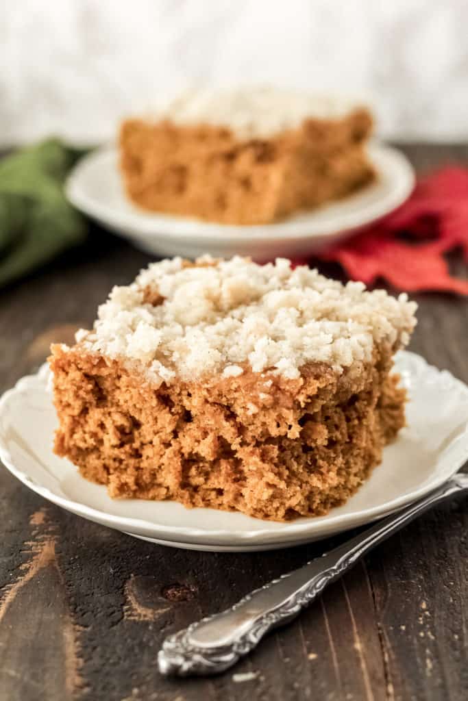 Side view of the front of a piece of fluffy pumpkin coffee cake on a plate.
