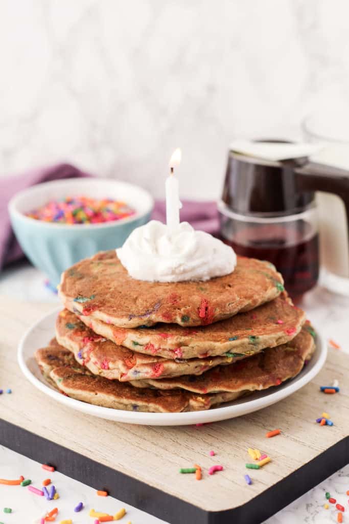 Plate of pancakes with a lit candle