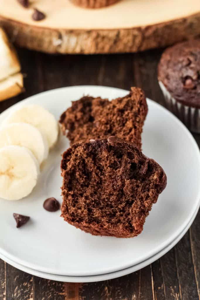A cut open chocolate muffin on a plate