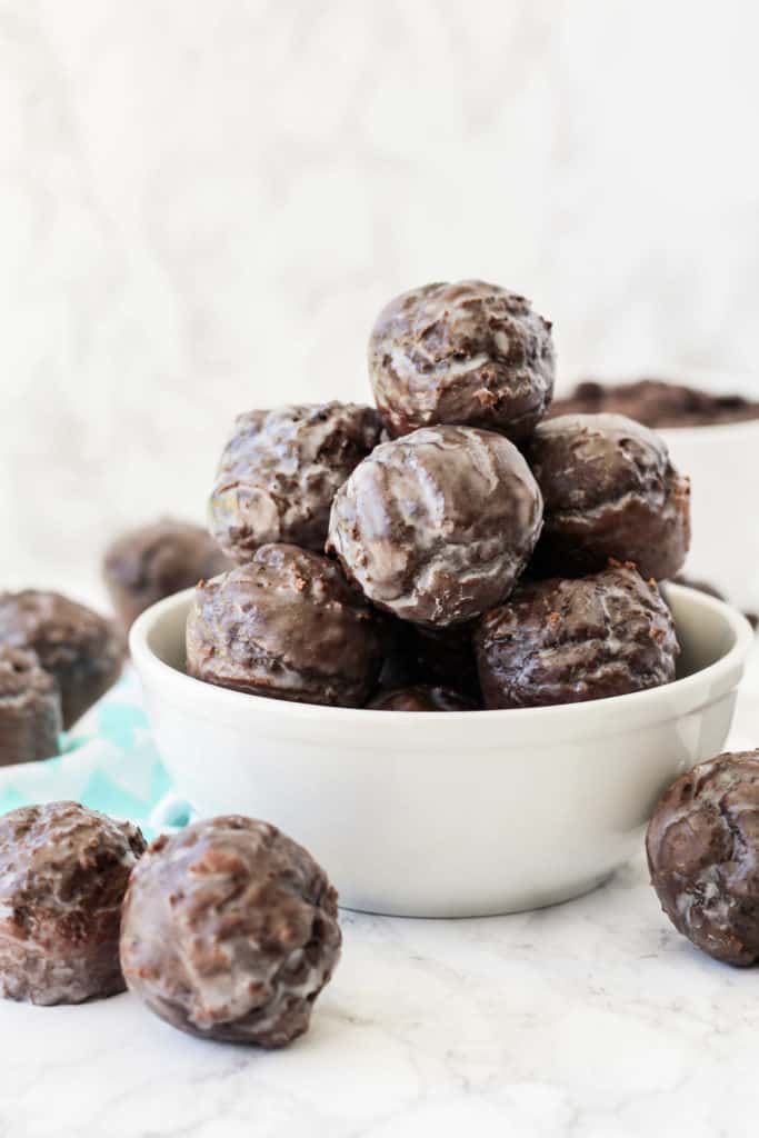 Chocolate donut holes stacked in a bowl